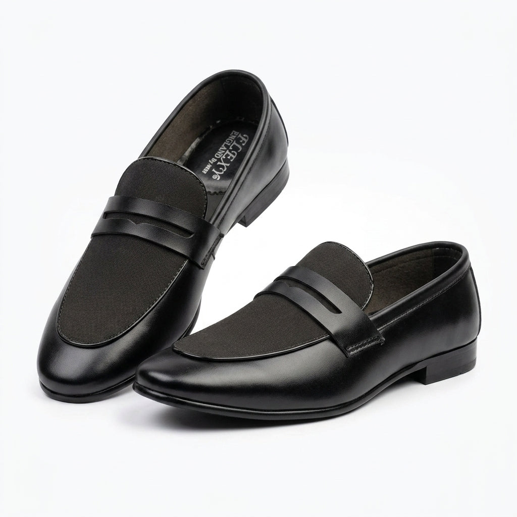 Black leather penny loafer pair clean studio shot white background