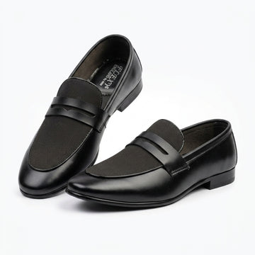Black leather penny loafer pair clean studio shot white background