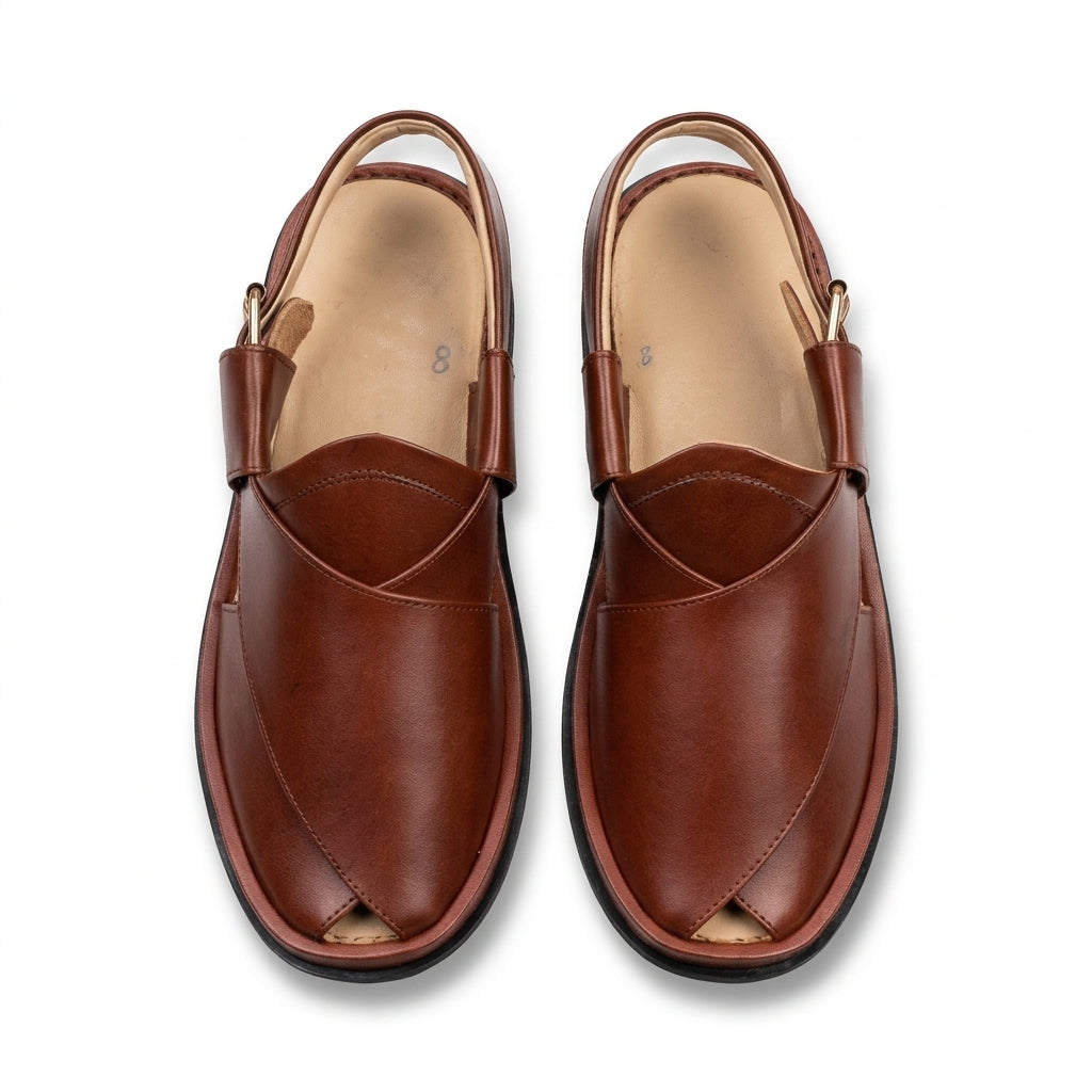 Tan cognac leather smooth-vamp Kaptaan Peshawari chappal pair top-down studio shot white background showing cross-strap vamp and gold pin buckle slingback