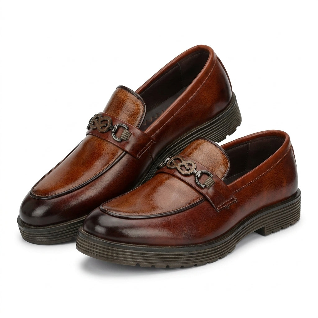 Tan burnished leather infinity-bit chunky loafer worn outdoors with navy trousers