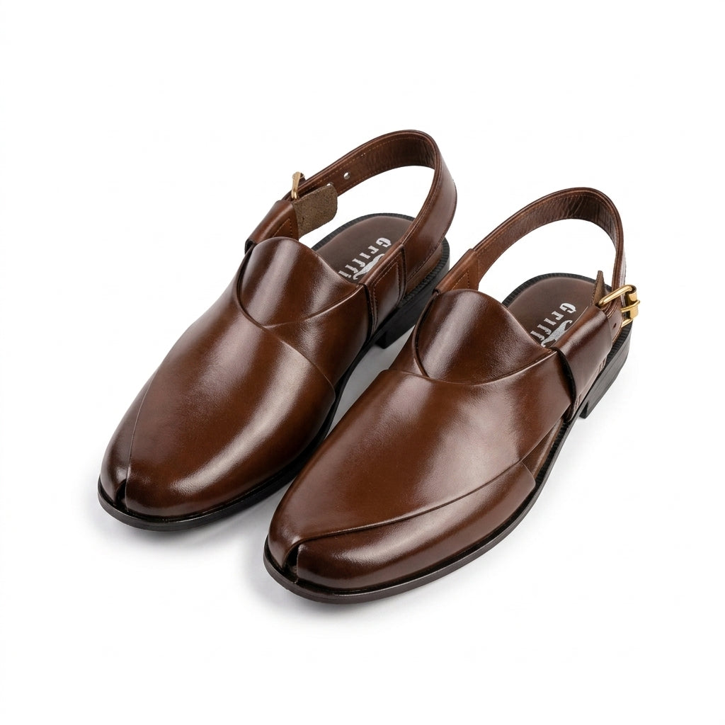 Brown leather plain-toe Peshawari slingback chappal pair clean studio shot white background showing gold buckle and sole
