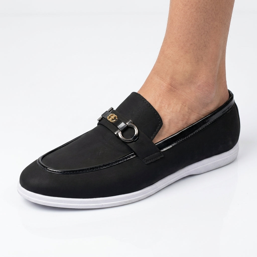 Dark brown patent quilted horsebit loafer with gold hardware worn with black socks