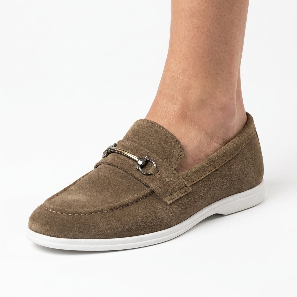 Brown suede horsebit loafer with white sole worn by man