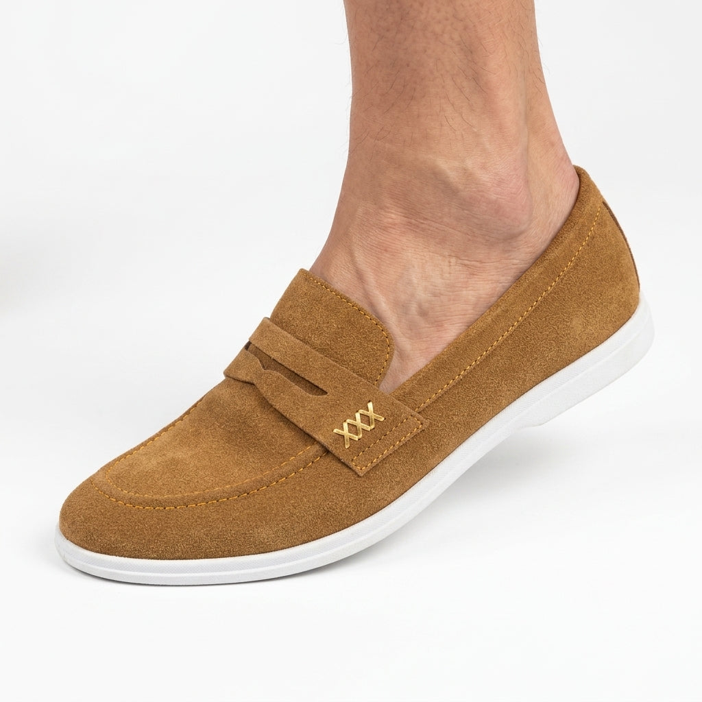 Tan suede penny loafer with white sole worn by man