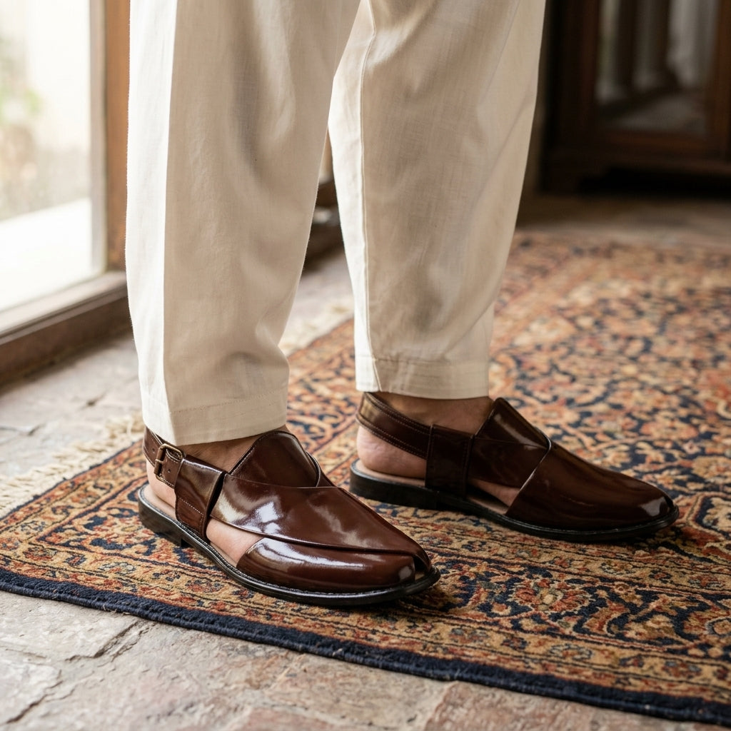 Dark chocolate Kaptaan chappal worn on Persian rug with cream shalwar kameez